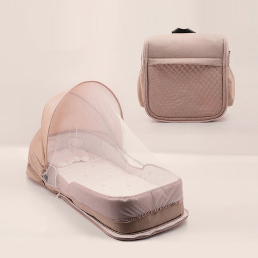 Baby bassinet with mosquito net and matching bag on a light background